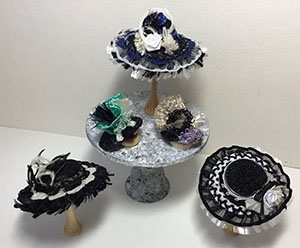 Assortment of Hats on Marble Table by Ginger Landon-Siegel